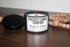 Prescott Candle Company candle with a label on a wooden surface