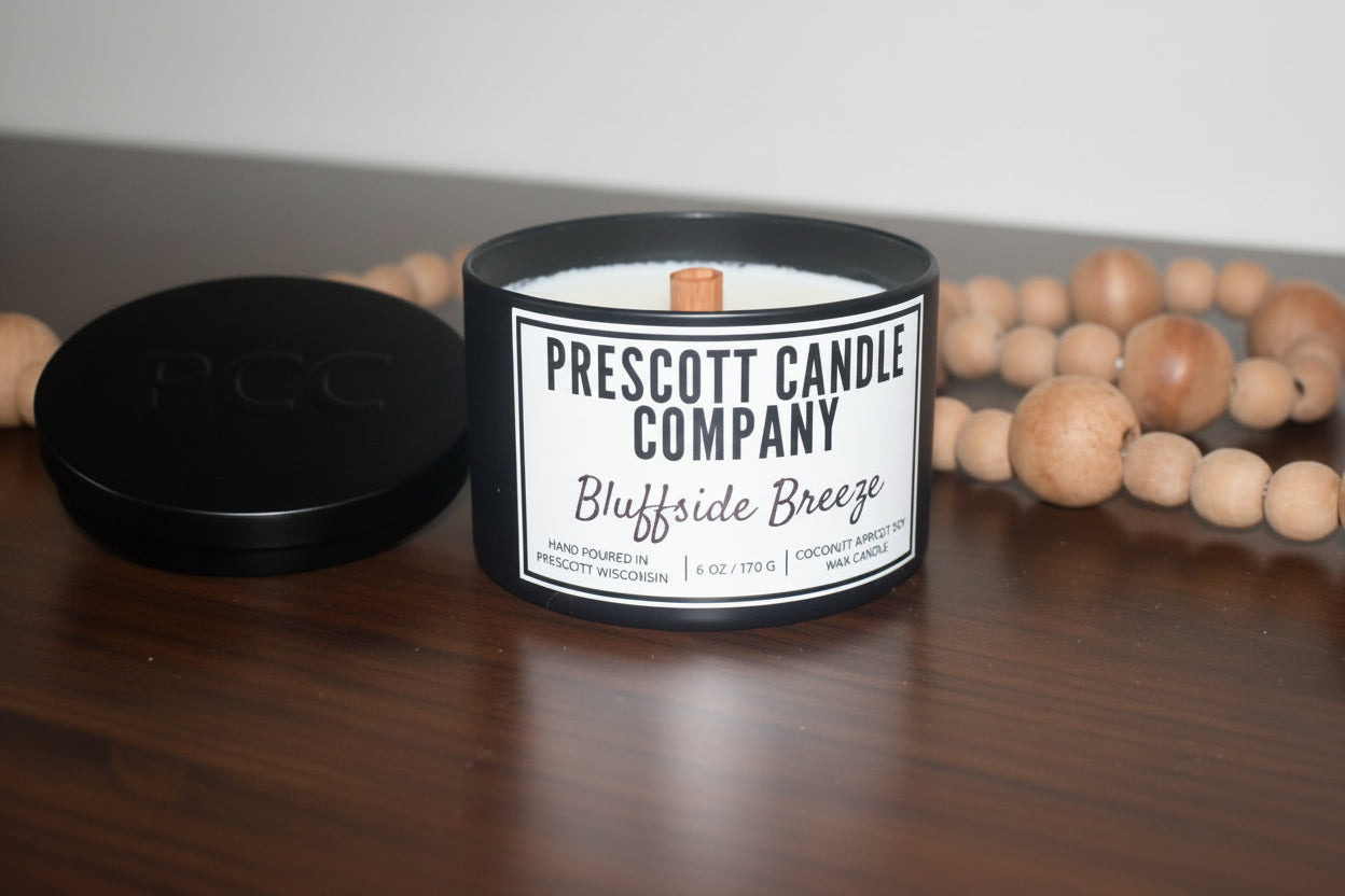 Prescott Candle Company candle with a label on a wooden surface